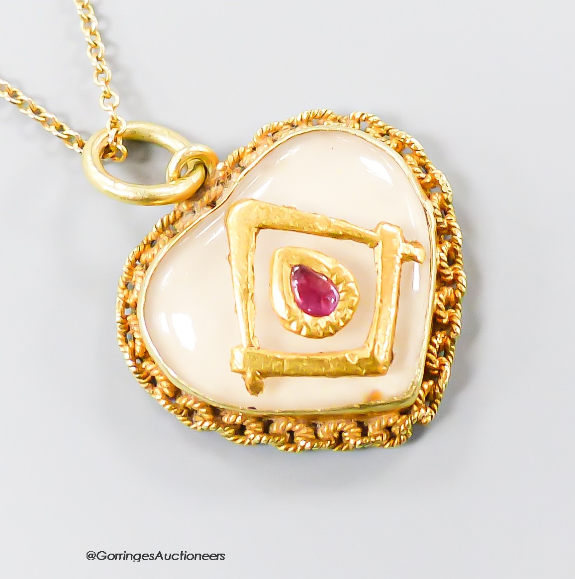 A yellow metal, ruby and paste? set heart shaped pendant with masonic motif, 17mm, on a 9ct chain, gross 4.1 grams.